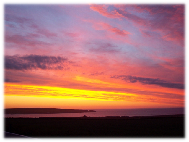 Thurso Bay, with the sun setting behind Holborn Head
